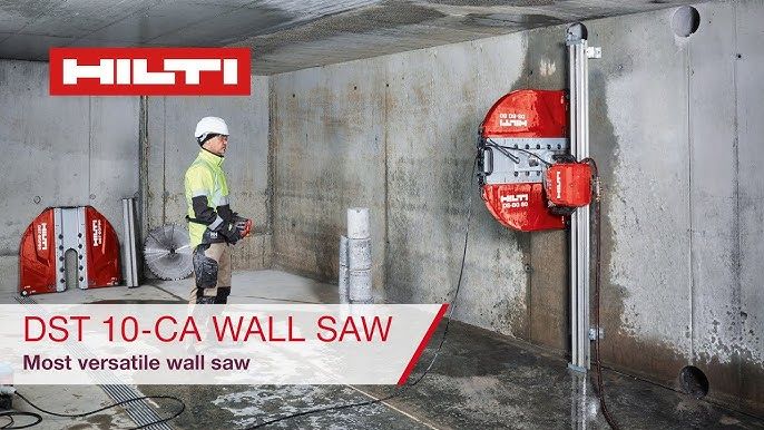 En operatør som styrer en rød Hilti veggsag på en betongvegg.